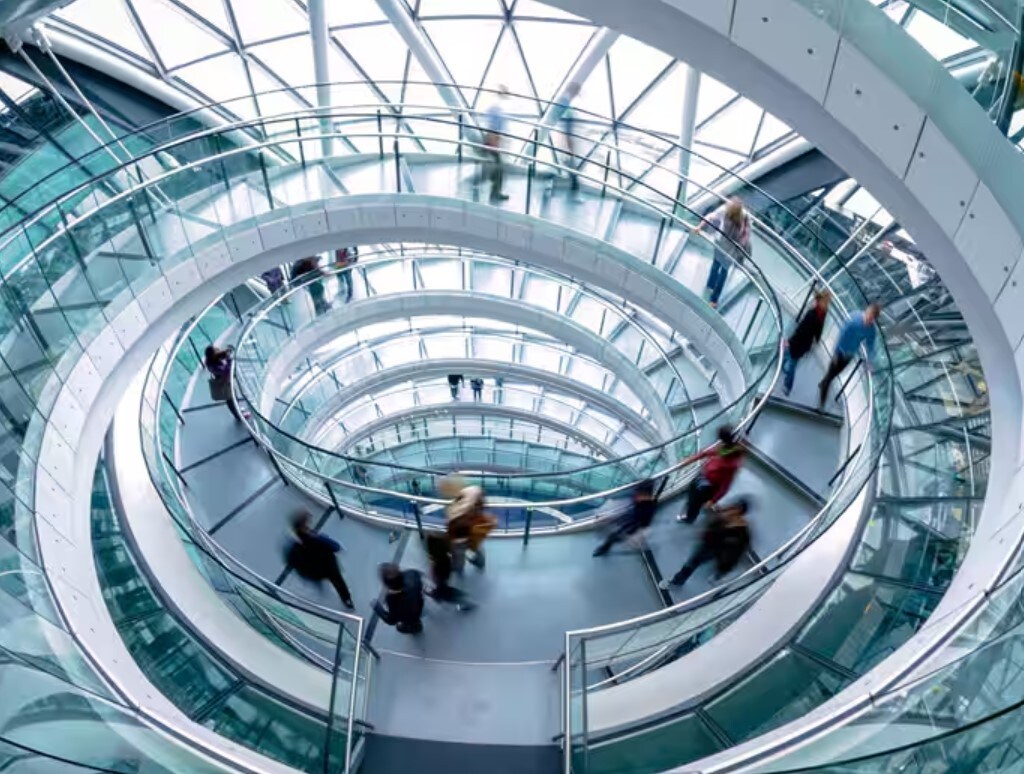 people walking on glass spiral staircase
