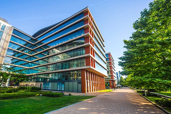 Office building next to a walkway and a garden