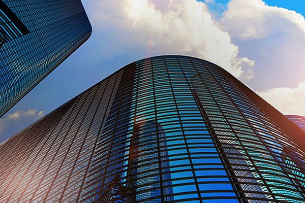 3D render illustration of the glass reflective office buildings skyscrapers against blue sky.