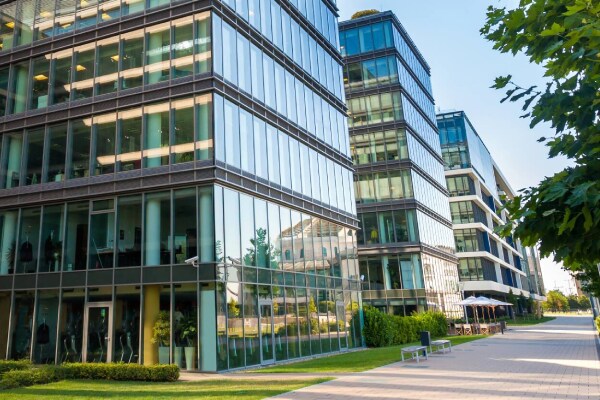 An office campus with a broad walkway and plenty of greenery