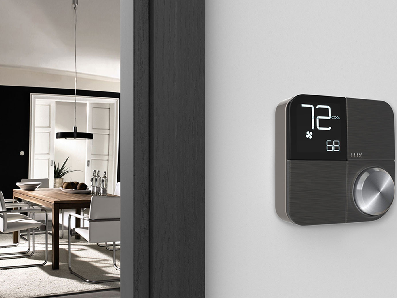 Smart thermostat installed on the wall outside a dining room