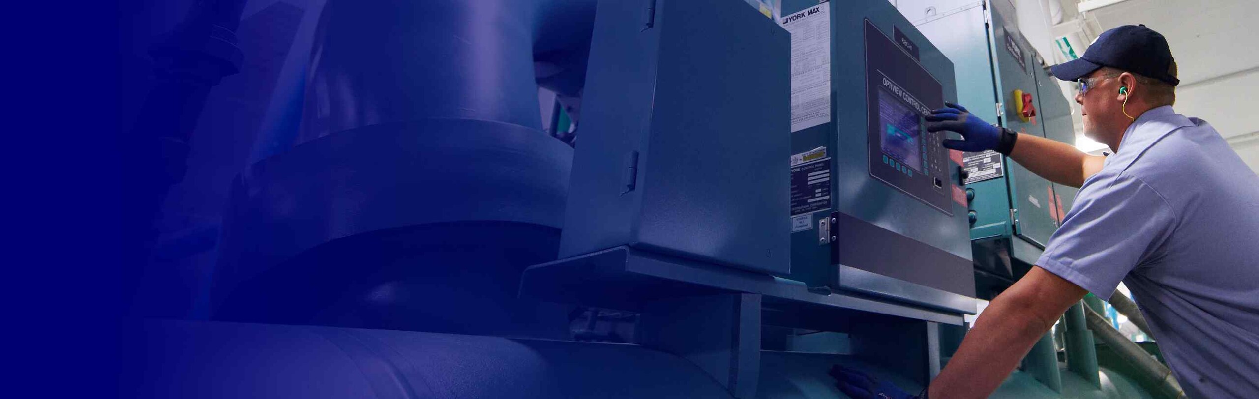 An HVAC engineer operating the controls of an HVAC unit in a facility